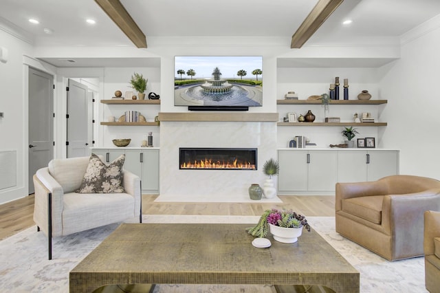 living area featuring light wood-type flooring, beam ceiling, recessed lighting, and a fireplace