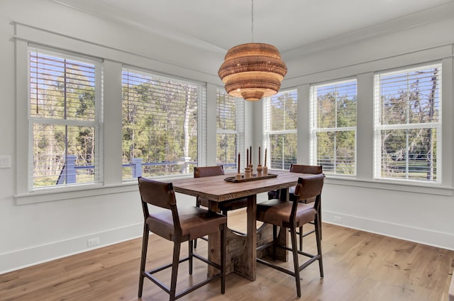 dining area featuring baseboards and light wood-style floors