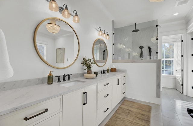full bathroom featuring double vanity, a sink, tile patterned flooring, and walk in shower