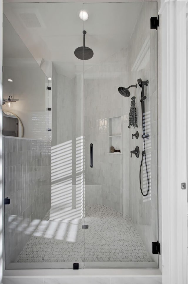 full bathroom featuring a stall shower and visible vents