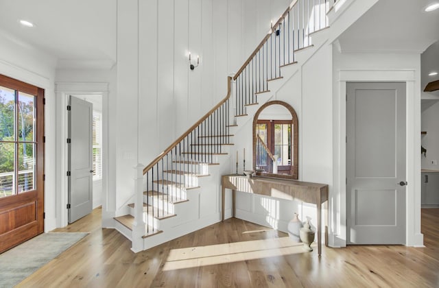 foyer entrance featuring recessed lighting, wood finished floors, and stairway
