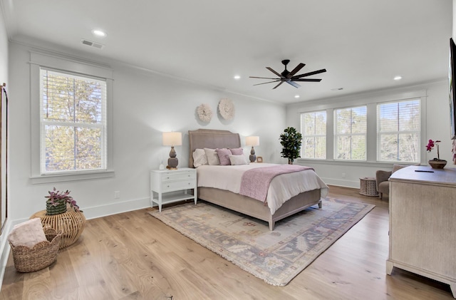bedroom with visible vents, crown molding, baseboards, wood finished floors, and recessed lighting