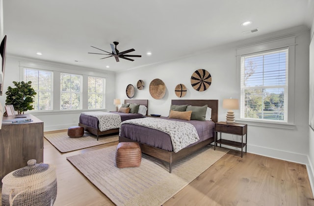 bedroom with light wood-type flooring, recessed lighting, baseboards, and visible vents