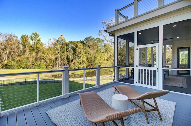 wooden terrace with a sunroom, fence, and a yard