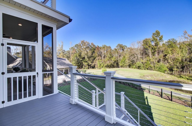 deck featuring a sunroom, fence, and a yard