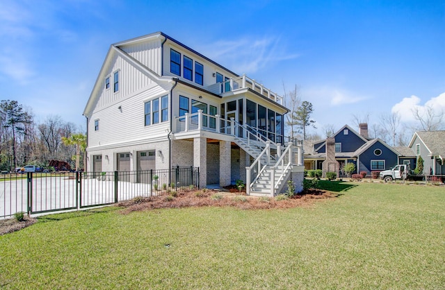 rear view of property with stairway, fence, an attached garage, board and batten siding, and a yard