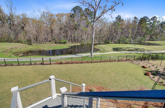 view of yard with a fenced backyard and a water view