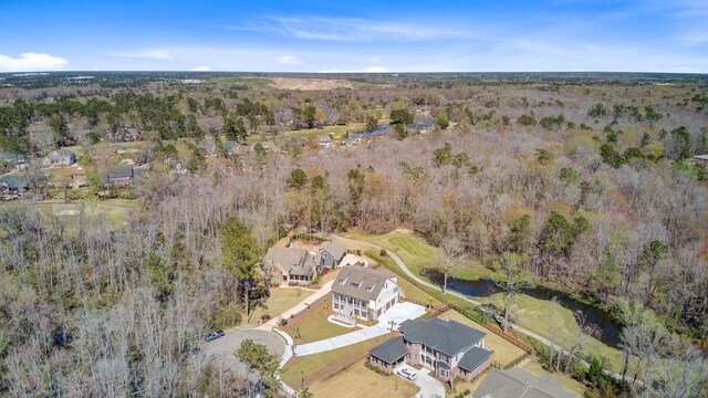 birds eye view of property with a view of trees