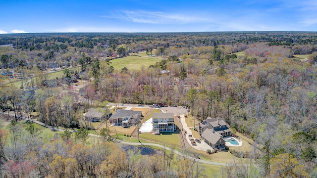 birds eye view of property with a forest view
