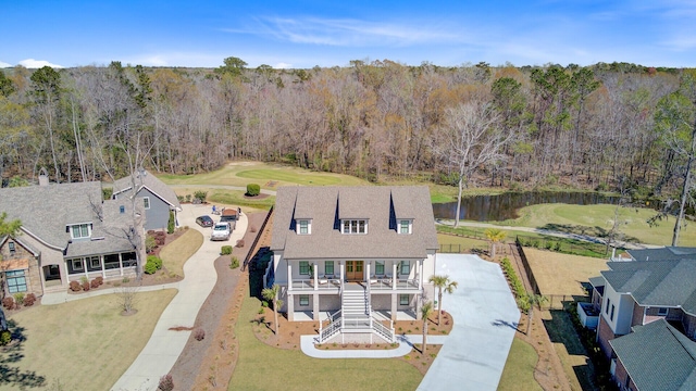 birds eye view of property featuring a view of trees