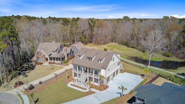 drone / aerial view featuring a water view and a forest view