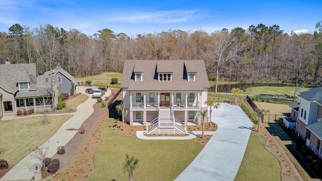 view of front of house with stairway, fence, driveway, a front yard, and covered porch