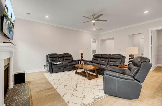 living room featuring ornamental molding, ceiling fan, and light hardwood / wood-style floors