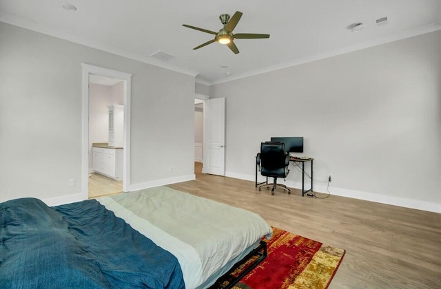 bedroom with ceiling fan, connected bathroom, light wood-type flooring, and crown molding