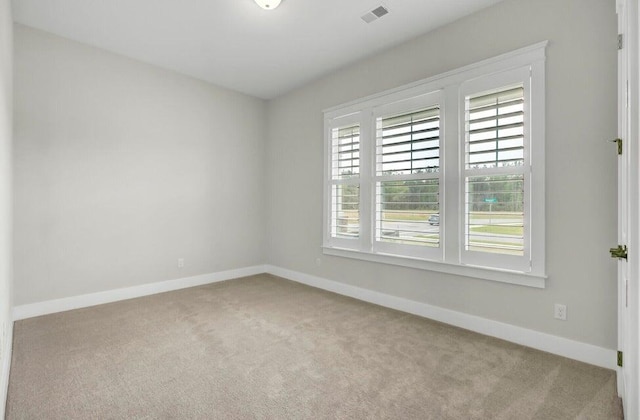 spare room with light colored carpet