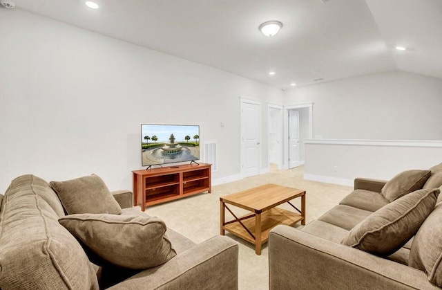 living room featuring light colored carpet and vaulted ceiling