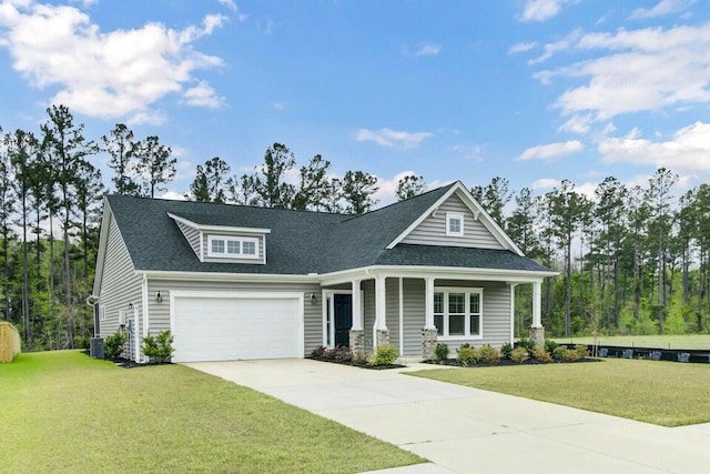 craftsman-style house with central air condition unit, a garage, and a front lawn