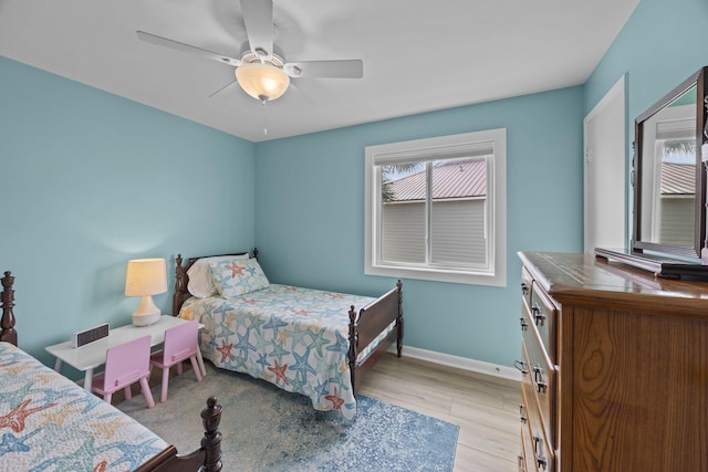 bedroom with ceiling fan and light hardwood / wood-style flooring