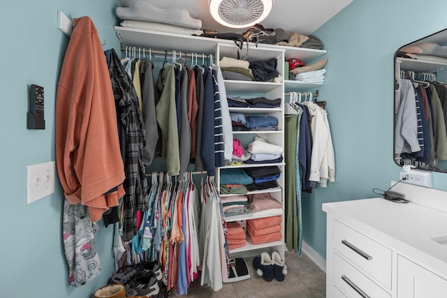 spacious closet featuring light tile patterned floors