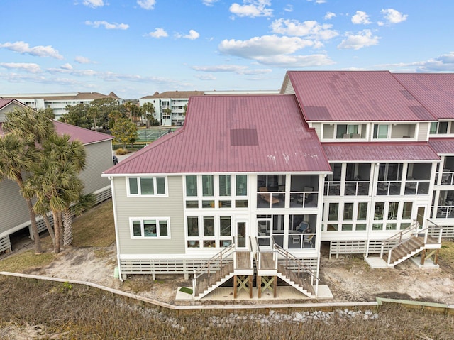 back of property with a sunroom