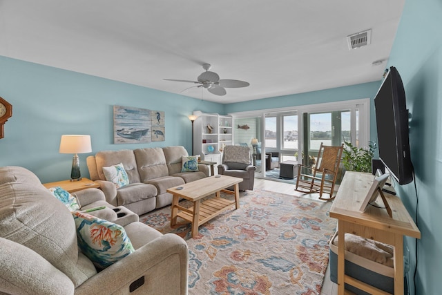 living room featuring ceiling fan and light hardwood / wood-style flooring