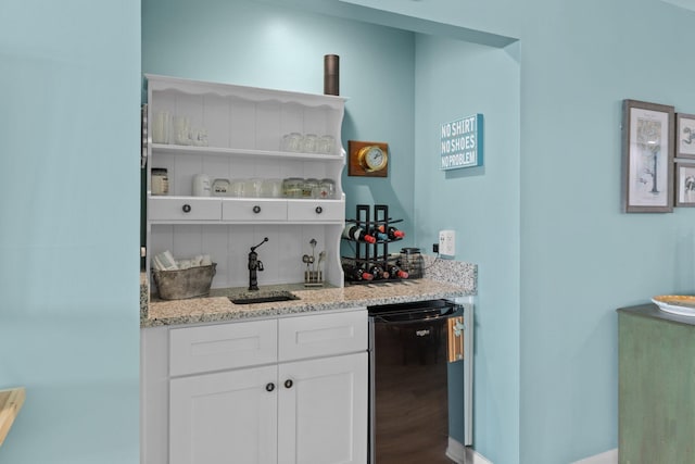 bar with white cabinetry, fridge, hardwood / wood-style floors, and light stone counters