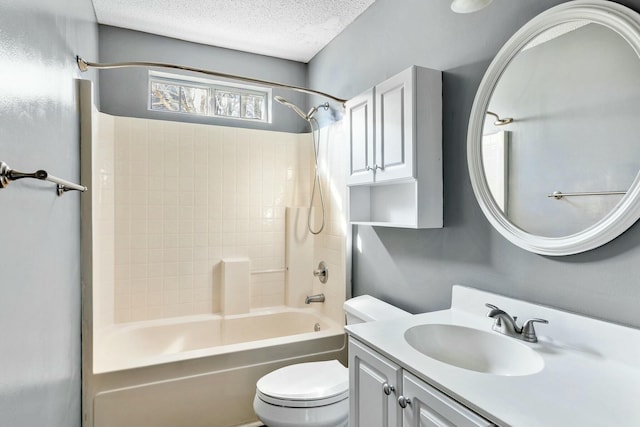 bathroom with a textured ceiling, vanity, shower / tub combination, and toilet