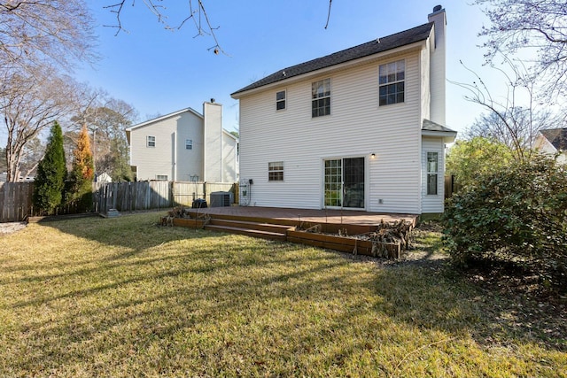 rear view of property with a lawn, a chimney, fence, a wooden deck, and central air condition unit