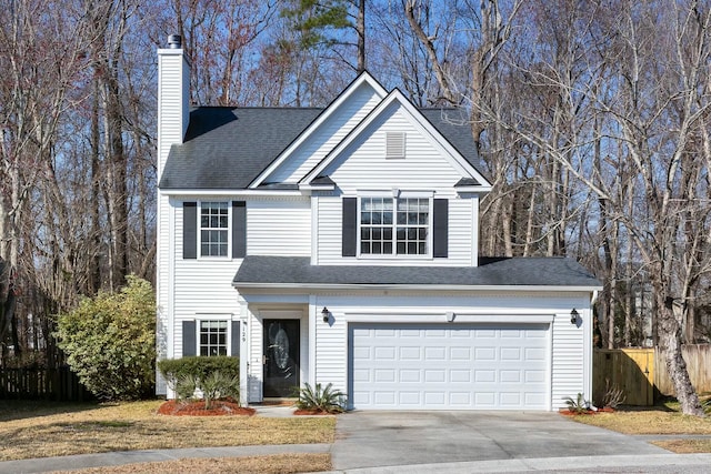 traditional-style house featuring a shingled roof, a chimney, fence, and concrete driveway