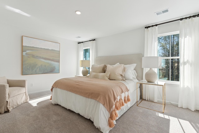 carpeted bedroom featuring visible vents and baseboards