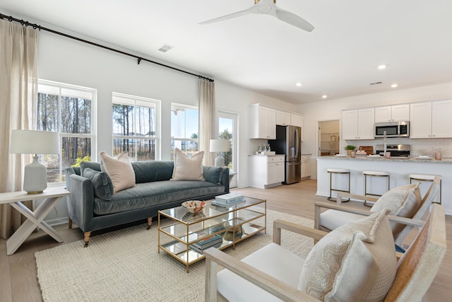 living room featuring recessed lighting, visible vents, ceiling fan, and light wood finished floors