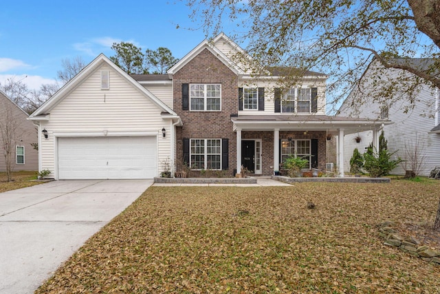 view of front of home with a garage, driveway, brick siding, a porch, and a front yard