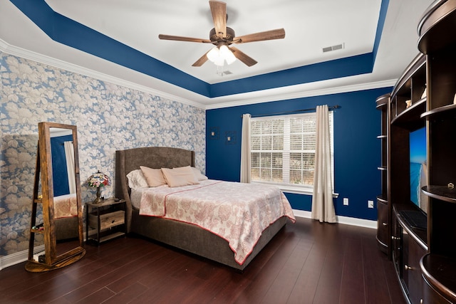 bedroom featuring baseboards, visible vents, a raised ceiling, and dark wood-style flooring