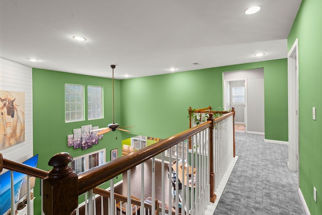 hallway featuring carpet floors, a wealth of natural light, an upstairs landing, and recessed lighting