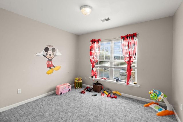 playroom with baseboards, visible vents, and carpet flooring