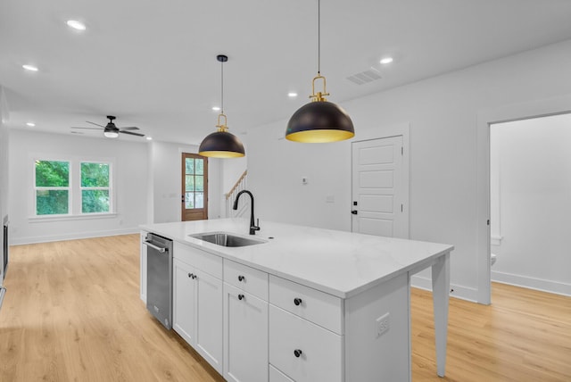 501 Joseph St, Charleston, SC 29412 - kitchen with light wood finished floors, dishwasher, white cabinets, pendant lighting, and light countertops