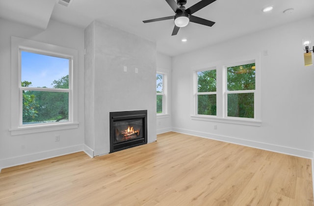 501 Joseph St, Charleston, SC 29412 - unfurnished living room with plenty of natural light, wood finished floors, a fireplace, a ceiling fan, and recessed lighting