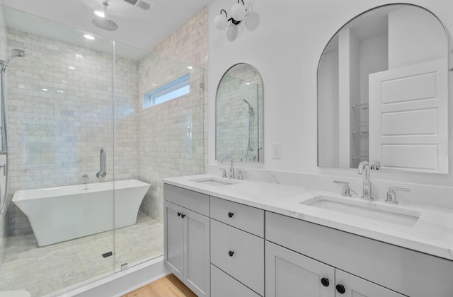 501 Joseph St, Charleston, SC 29412 - full bath featuring a freestanding tub, double vanity, a stall shower, and wood finished floors
