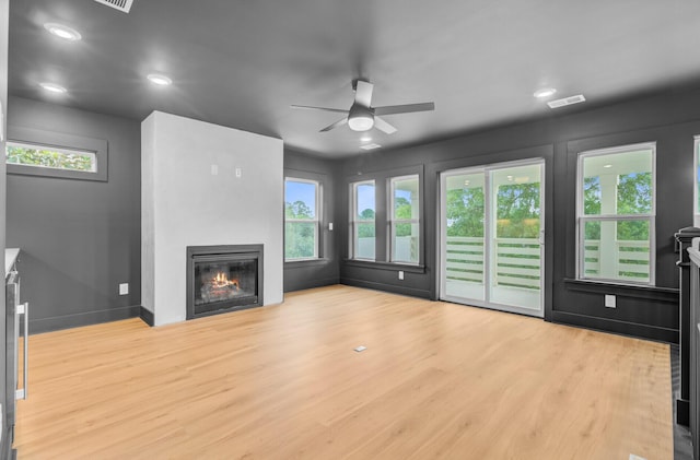 501 Joseph St, Charleston, SC 29412 - unfurnished living room with ceiling fan, a glass covered fireplace, plenty of natural light, wood finished floors, and recessed lighting