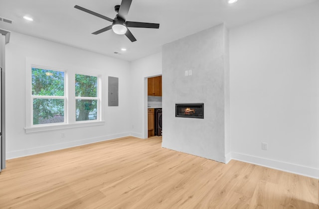 501 Joseph St, Charleston, SC 29412 - unfurnished living room with electric panel, ceiling fan, light wood-style floors, a large fireplace, and recessed lighting