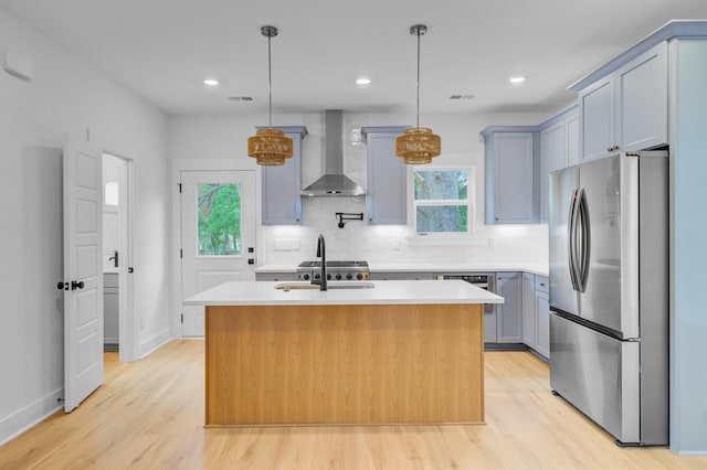 501 Joseph St, Charleston, SC 29412 - kitchen featuring freestanding refrigerator, wall chimney range hood, light wood-style floors, light countertops, and recessed lighting