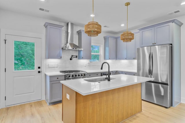 501 Joseph St, Charleston, SC 29412 - kitchen with freestanding refrigerator, wall chimney range hood, gray cabinets, and recessed lighting