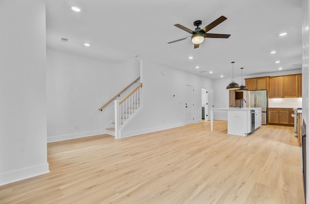 501 Joseph St, Charleston, SC 29412 - unfurnished living room with recessed lighting, a ceiling fan, light wood finished floors, and stairway
