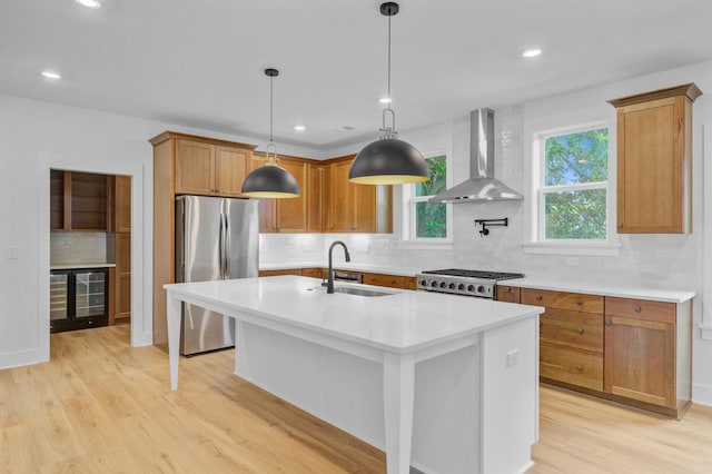 501 Joseph St, Charleston, SC 29412 - kitchen with wall chimney exhaust hood, freestanding refrigerator, beverage cooler, range, and tasteful backsplash