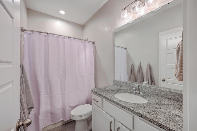 bathroom featuring a shower with curtain, toilet, vanity, and tile patterned flooring