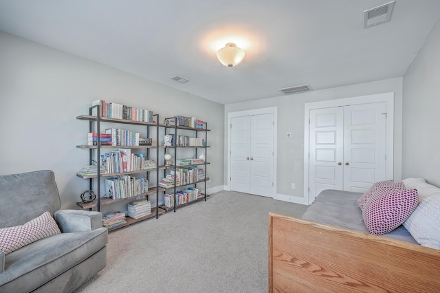 living area with carpet flooring, baseboards, and visible vents