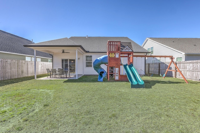 view of play area with a lawn, a fenced backyard, a ceiling fan, and a patio area