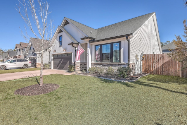 view of front of house with stone siding, concrete driveway, a front lawn, and fence