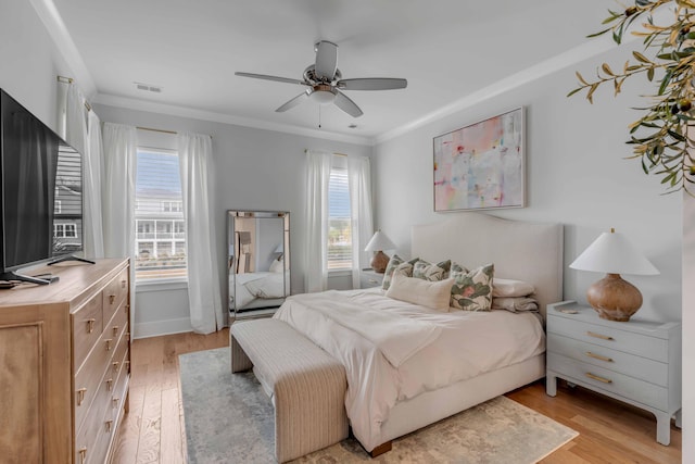 bedroom with ceiling fan, light hardwood / wood-style flooring, and ornamental molding