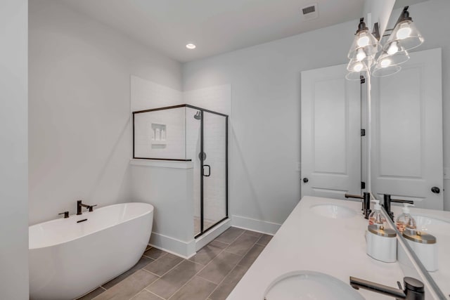 bathroom featuring vanity and separate shower and tub